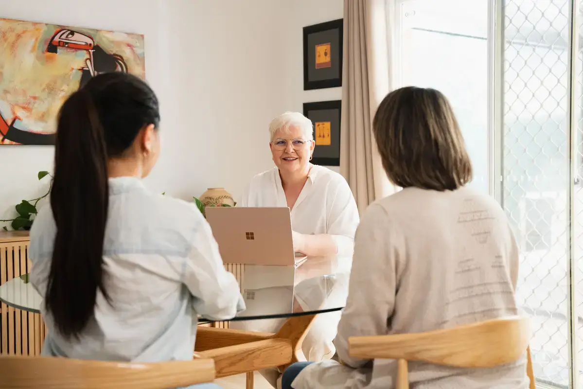 Michelle Hasani facilitating a wellbeing in the workpalce, wellbeing strategy conversation with two clients, focused on building resilience and wellbeing in the workplace.