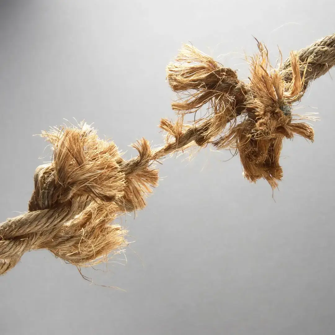 Fraying rope symbolising workplace pressure, burnout, and leadership strain.