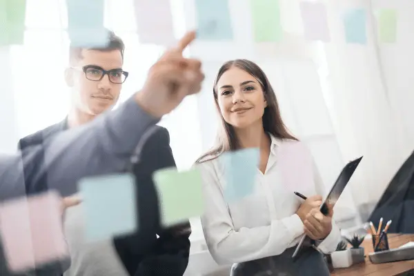 psychological safety in the workplace australia. Leadership team discussing ideas in a meeting.